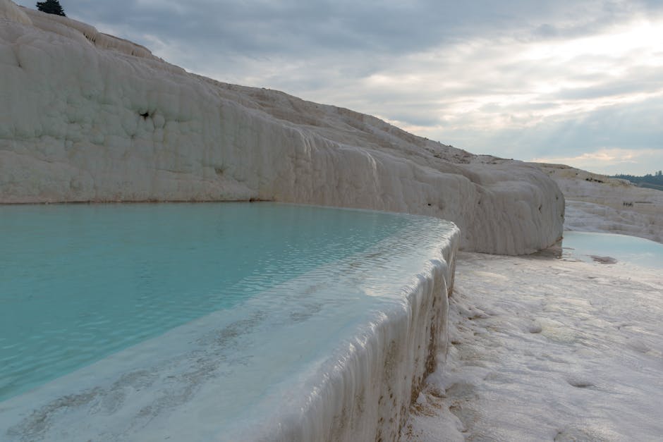 Scenic view of Pamukkale's iconic thermal terraces with turquoise waters in Turkey.